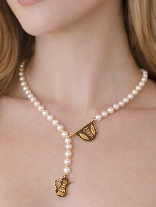 Pearl lariat necklace with a gold cedar pendant