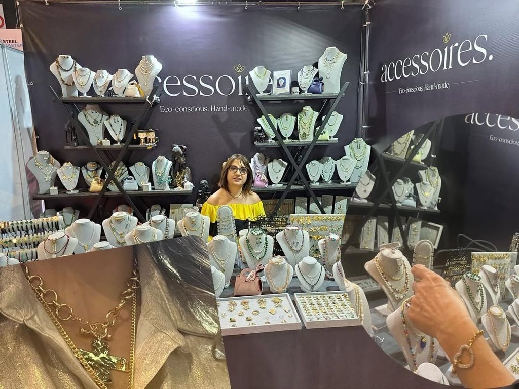 The Accessoires stand, necklaces laid out on linen busts beneath the studio sign
